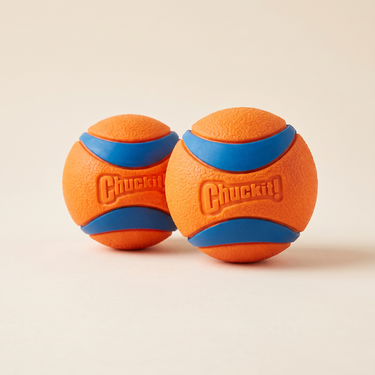 Two Chuckit! Ultra Balls, orange with blue bands