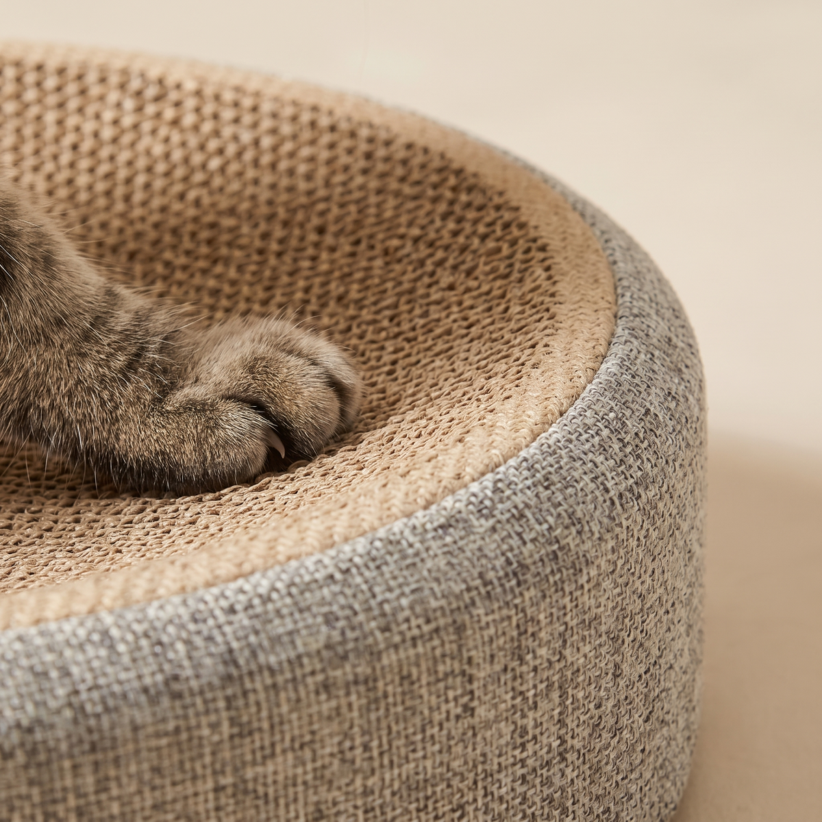 Close up of the woven sisal top and linen outer wall of the oval cat scratcher bed